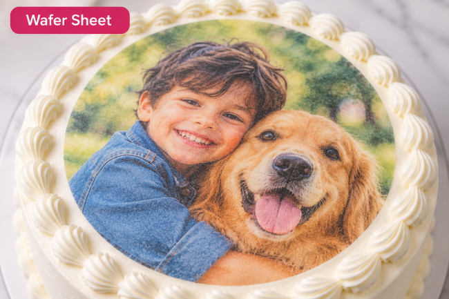 Edible images for cakes featuring a child and dog photo printed on a wafer sheet atop a frosted cake. 